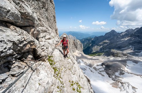 Mountaineer with helmet in a secured via ferrata, Zugspitz via ferrata, ascent to the Zugspitze,