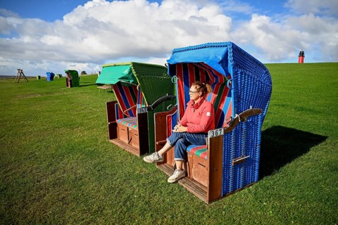 Woman in a beach chair on the island of Pellworm, Wadden Sea National Park, North Frisia, Germany,