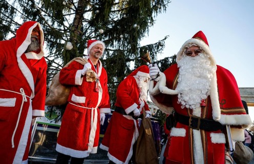 Assembly of Santas and angels of the Berlin Father Christmas Centre at the Brandenburg Tor, Berlin,