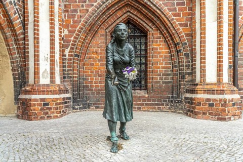 Grete-Minde monument in front of the historic town hall in Tangermünde, Saxony-Anhalt, Germany,