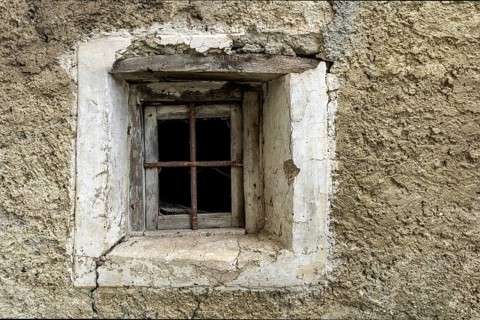 Dilapidated window of an old house in the mountain village of Bordei, Centovalli, Canton Ticino,