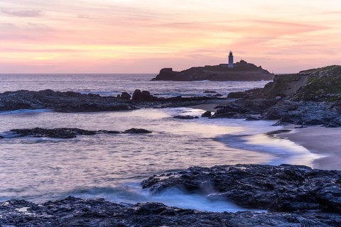 Godrevy Lighthouse, the lighthouse of Godrevy on Godrevy Island. In the evening at sunset. Long