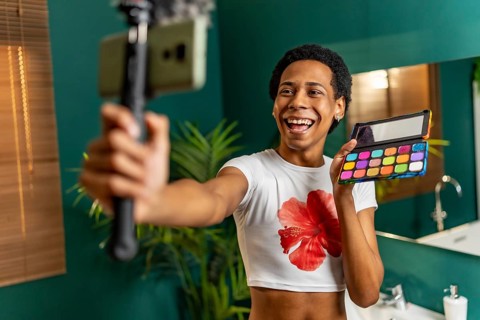 Lgtb man latin vlogger recording make up tutorial at home