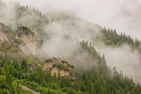 Wisps of mist cover the Karwendel mountains in the Großer Ahornboden nature reserve, Eng Valley,