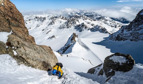 Mountaineer with ice axe and crampons, ascent through steep snowfield to Piz Kesch or Piz d'Es-cha