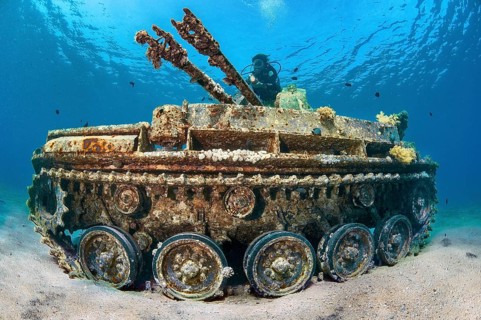 Underwater photo of diver swimming above looking at as an attraction for underwater sportsmen