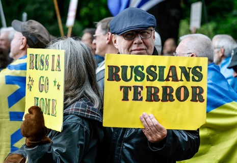 Ukrainians holding placards with the slogan Russia go home at the counter-demonstration Your peace
