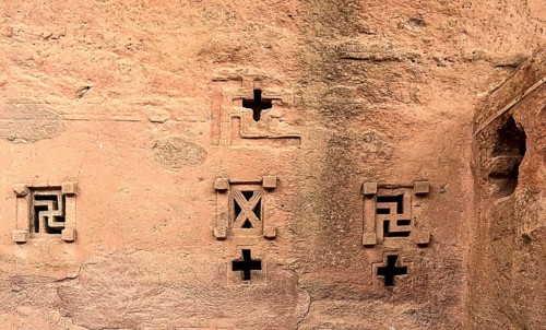 Cross-shaped windows carved in stone in the underground monolithic rock-hewn church of Biete