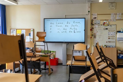 Classroom of a fourth grade, after school, the building is older but in good condition, modern