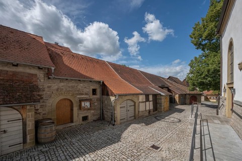 Inner courtyard with former church arcades, barns and St John's Church in the historic fortified