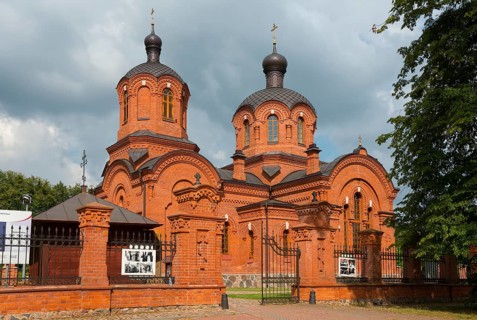 Orthodox church with two red-brick domes, enveloped in dramatic clouds, Orthodox Church of St