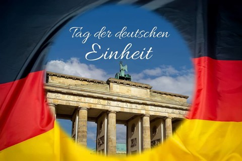 Brandenburg Tor in Berlin on a German flag (Composing), with the lettering DAY OF GERMAN UNITY