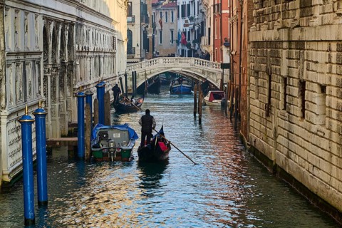 View from 'Ponte della paglia' over a waterway on a sunny morning with gondolier in Venice on a
