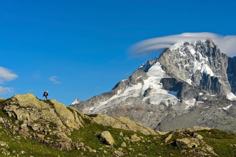 Hikers in the Aiguilles Rouges nature reserve against the impressive backdrop of the summit of the