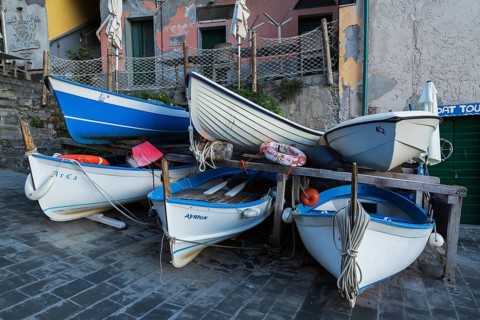 Close-up of stored white and blue traditional fishing boats on dry land, Riomaggiore, Cinque Terre,