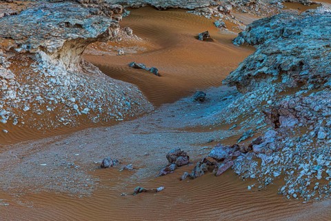 Striking cliffs surrounded by windswept sand structures, Huqf stone desert, Arabian Peninsula,
