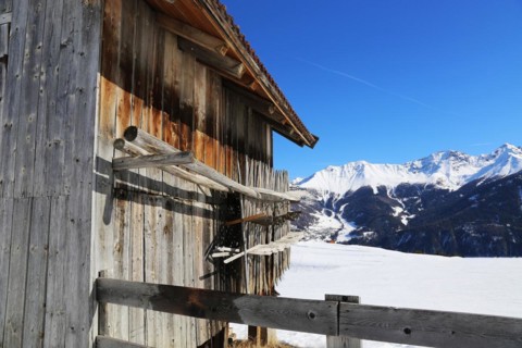 The Serfaus, Fiss, Ladis ski area in winter. In the foreground a wooden hut typical of the