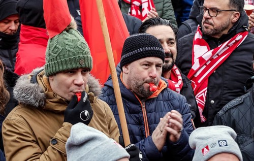 Volkswagen employees demonstrate with whistles in front of the Volkswagen Arena during the