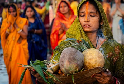 Hindu devotees perform rituals as they offer prayers to the Sun god in the bank of Brahmaputra