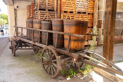 Wine barrels on a historic wooden cart, Ribeauville, Alsace, France, Europe