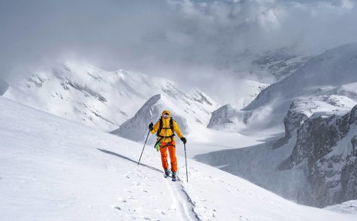Ski tourers climbing the Wildhorn, Snowy mountain landscape and fog, Bernese Alps, Bernese