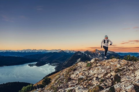 Trail running in autumn on the Jochberg on Lake Walchensee against the wonderful backdrop of the
