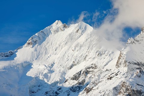 Freshly snow-covered summit of Piz Bernina and Biancograt, Engadin in the canton of Graubünden,
