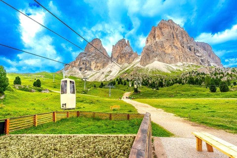 Cable car ascending to the sassolungo group, with its majestic peaks, located in the italian