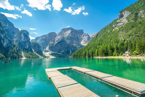 Breathtaking landscape with emerald green water and majestic peaks in the italian dolomites,