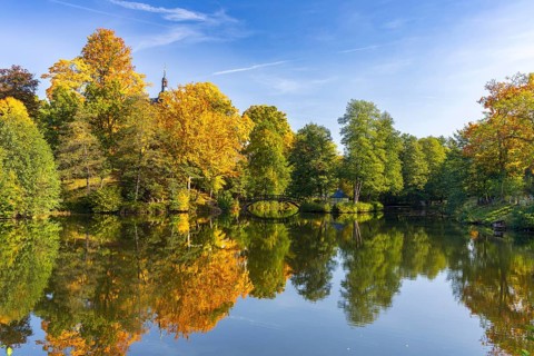 Castle pond with bridge and Pfaffroda Castle in autumn, Olbernhau, Erzgebirge, Saxony, Germany,