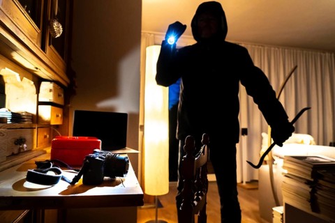 Symbolic image of a burglary, perpetrator has broken into a flat from the garden side and is