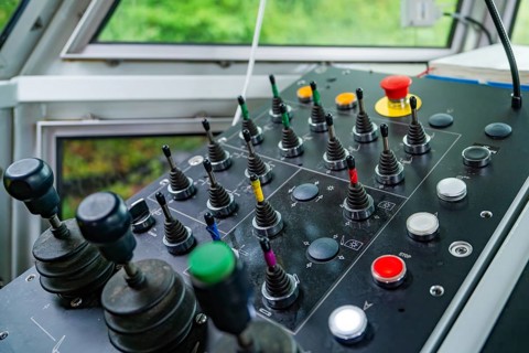 Detail of a control panel with numerous colour-coded levers and buttons, Hermann Hesse Bahn track