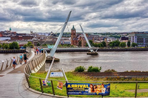 City view with a striking bridge in the foreground and a dense cloud backdrop, Londonderry