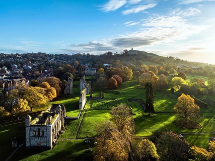 Sunrise over Glastonbury Abbey from a drone, Glastonbury, Somerset, England, United Kingdom, Europe