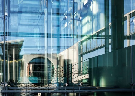 The Marie-Elisabeth Lüders House is reflected in the window of the Paul Löbe House, both parliament