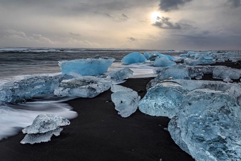 Ice floes on the beach, waves, sea, clouds, sunlight, winter, Diamond Beach, Breidamerkursandur,