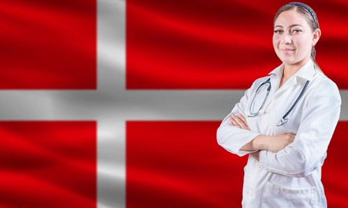 Female doctor on danish flag. Doctor with crossed arms on danish flag. Denmark health and care