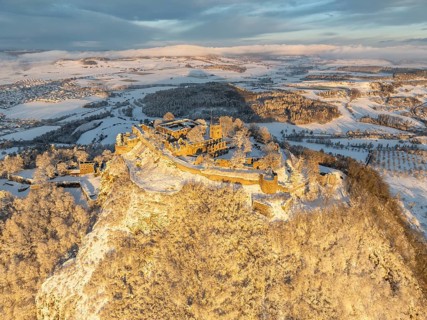 Aerial view of the snow-covered Hegau volcano Hohentwiel with Germany's largest castle ruins on a