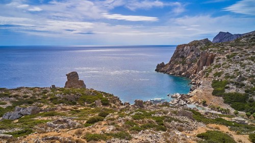 Palatia Beach, Palatia, coastal landscape with rocky views and calm sea under an expansive sky,