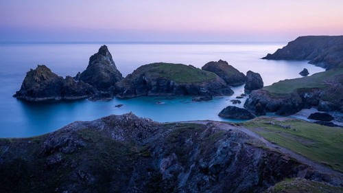 Kynance Cove with Asparagus Island, with sea, sandy beach and rocks in the evening. Coastal