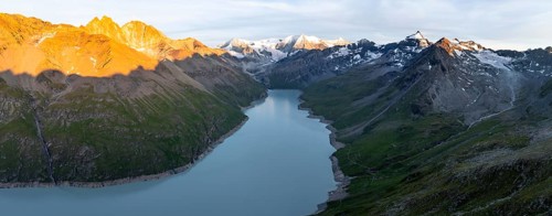 Alpine panorama with Pigne d'Arolla, Lac de Dix, sunset in the mountains, reservoir, Valais Alps,