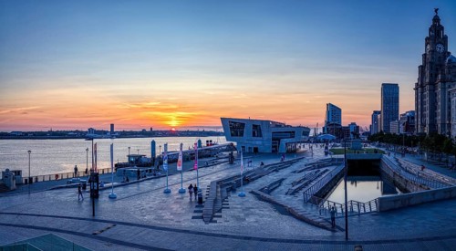 Modern harbour view at sunset with river and city in the background, Liverpool