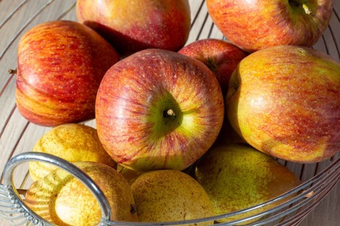 Close-up of apples and pears in the fruit basket
