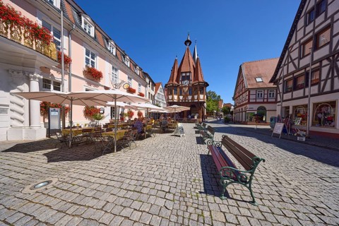Market square with historic town hall, benches and outdoor area of a café in Michelstadt, Odenwald,