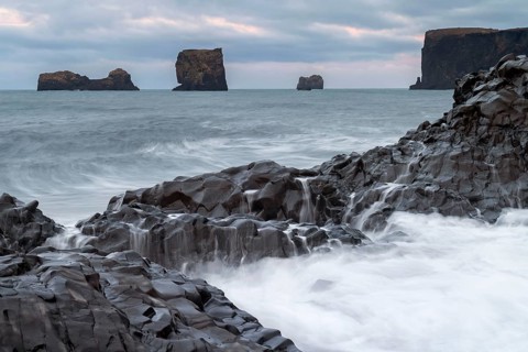 Waves, surf, washed over columnar basalt, rock needles, long exposure, Dyrhólafjara, rock gate