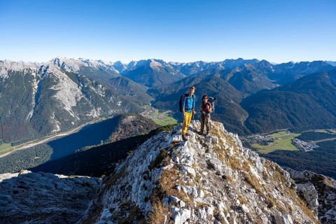 Mountaineer at the summit of the Große Arnspitze, mountain panorama with Karwendel mountains,