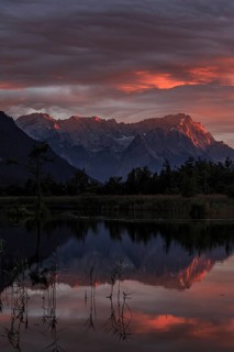 Mountains reflected in lake, sunset, cloudy mood, alpenglow, summer, seven springs, behind