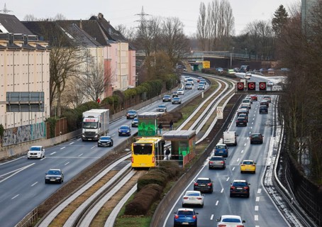Essen, North Rhine-Westphalia, Germany - Cars and a public bus drive through Essen city centre on