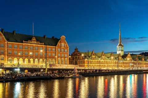 The former stock exchange Børsen and C.F. Tietgens Hus on Holmens Canal at dusk, Copenhagen,