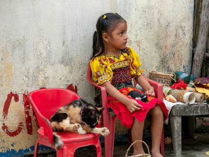 Bocas del Toro Indigenous Guna child with cat on San Blas Islands Panama